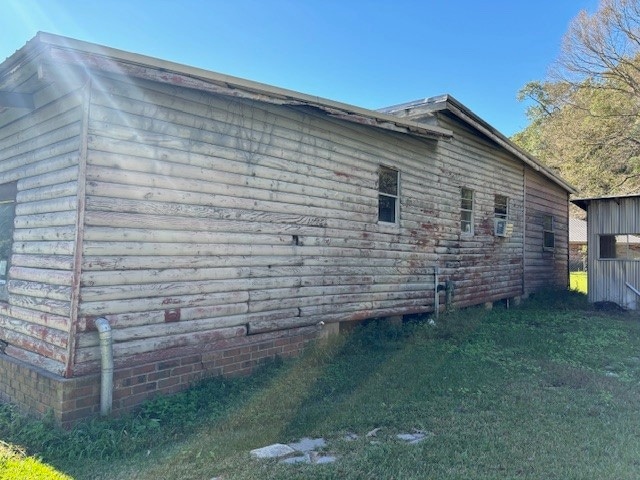 view of side of property with a lawn