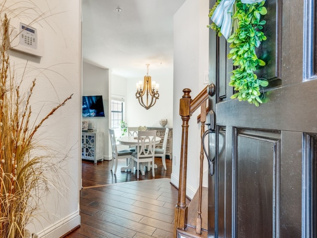 entrance foyer featuring a chandelier and dark wood-type flooring