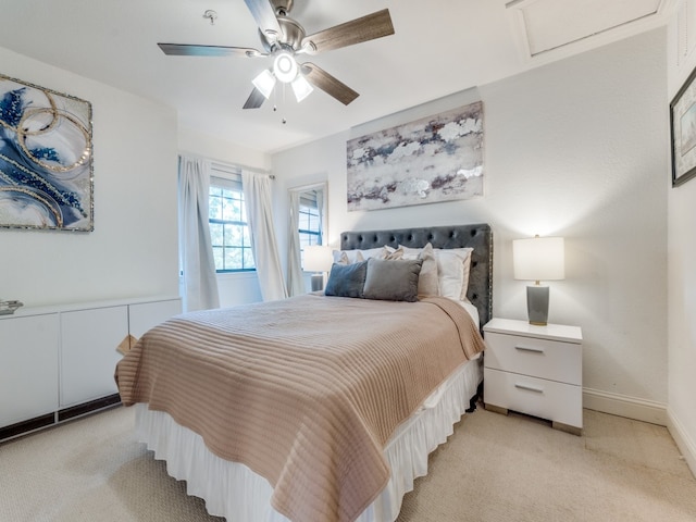 bedroom with light colored carpet and ceiling fan