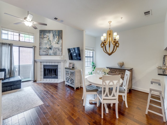 dining space with a fireplace, a wealth of natural light, and dark wood-type flooring