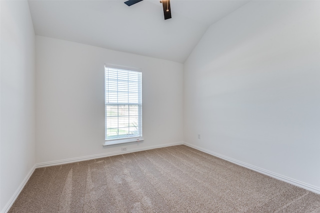 carpeted empty room with vaulted ceiling and ceiling fan