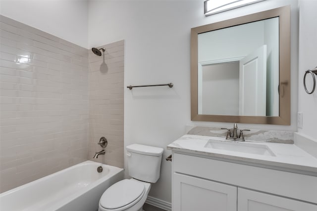 full bathroom featuring vanity, tiled shower / bath combo, and toilet