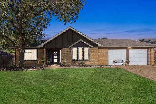 ranch-style house featuring a yard and a garage