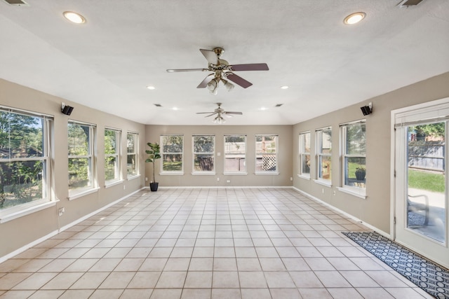 unfurnished sunroom featuring ceiling fan