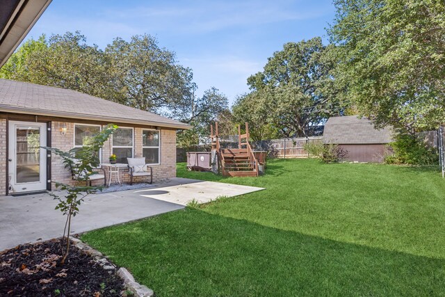 view of yard featuring a patio and a shed