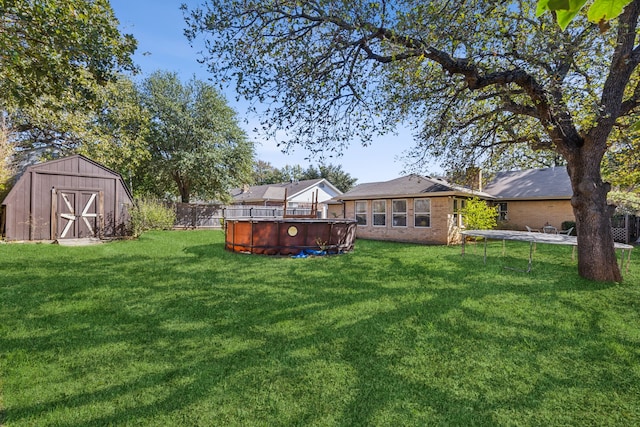 back of house with a yard, a fenced in pool, and a storage unit