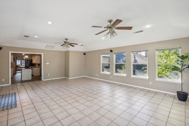 tiled empty room with ceiling fan and lofted ceiling