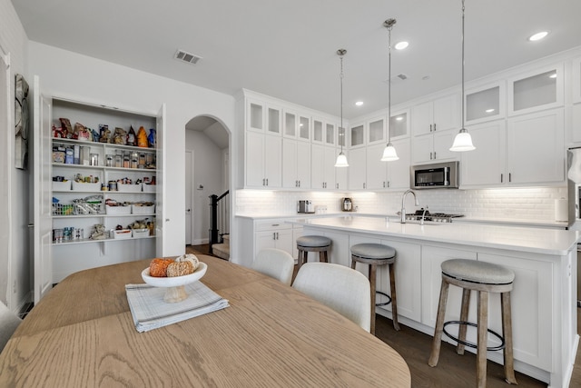 dining space with dark hardwood / wood-style flooring and sink