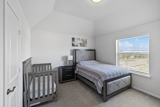 carpeted bedroom with lofted ceiling