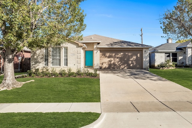 view of front of property featuring a garage and a front lawn