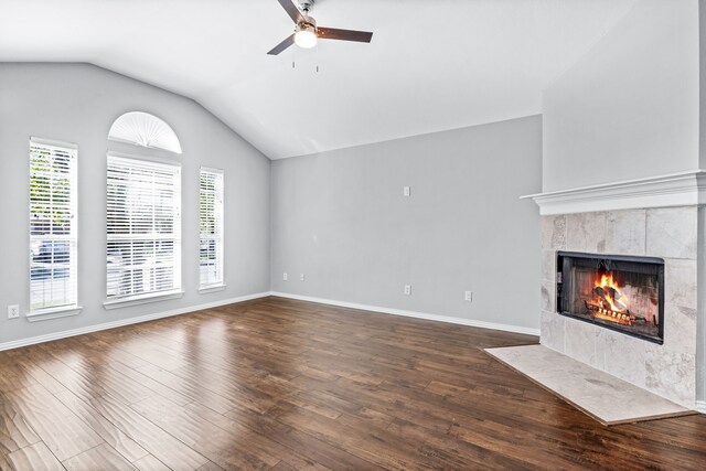 unfurnished living room with ceiling fan, dark hardwood / wood-style floors, a premium fireplace, and lofted ceiling