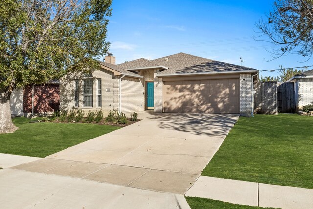 view of front of home with a garage and a front lawn