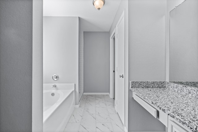 bathroom featuring a washtub and vanity