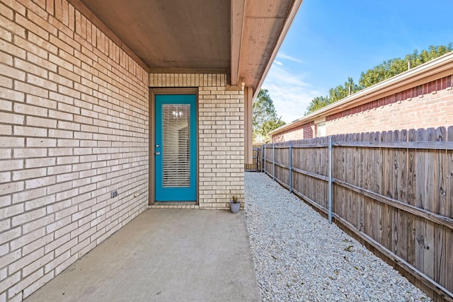 view of exterior entry featuring a patio