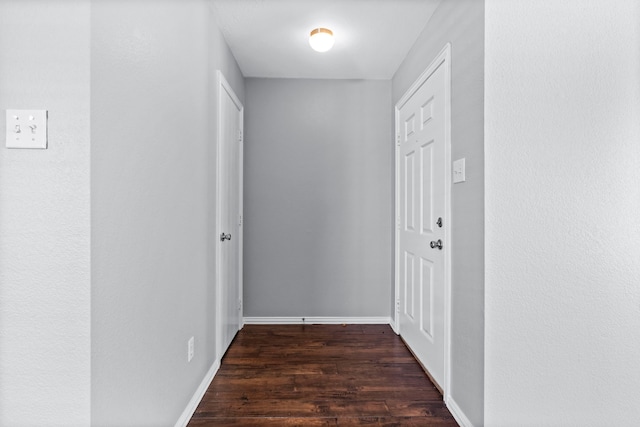 hallway with dark wood-type flooring