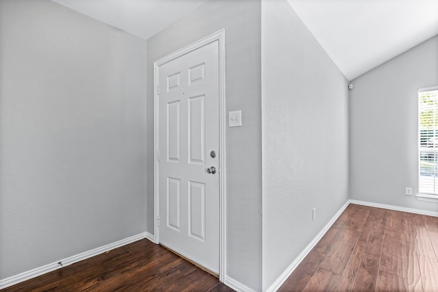 entrance foyer featuring dark hardwood / wood-style flooring and lofted ceiling