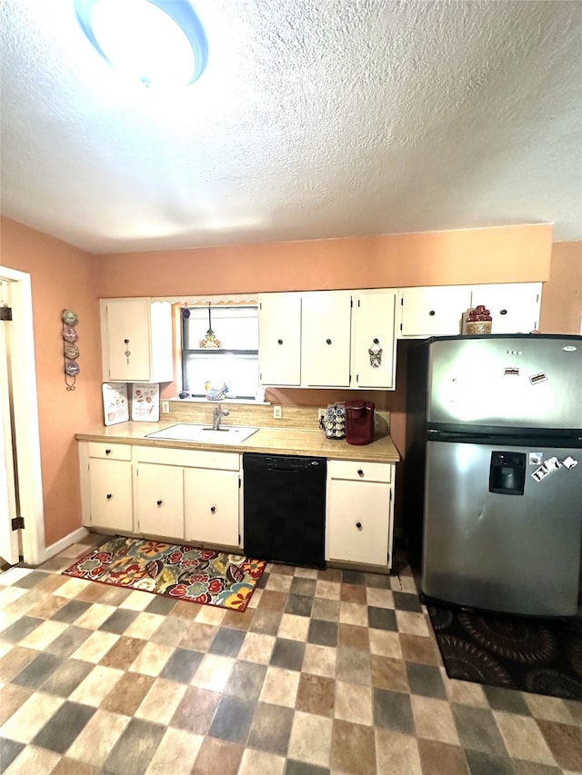 kitchen featuring stainless steel fridge, a textured ceiling, sink, dishwasher, and white cabinetry