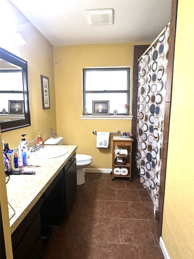 bathroom with tile patterned floors, vanity, and toilet