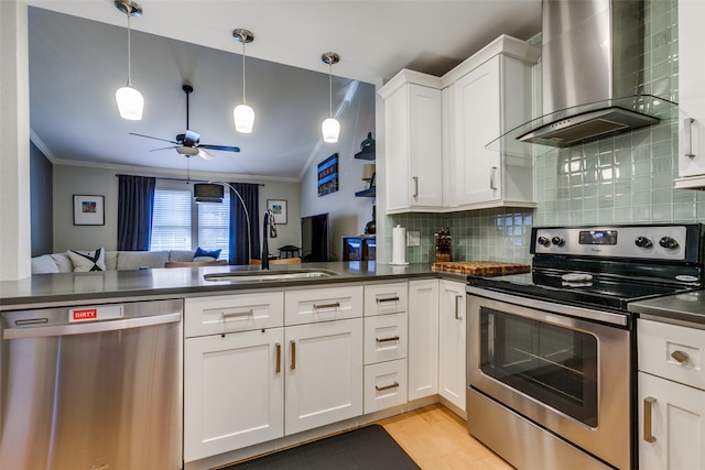 kitchen with white cabinetry, sink, stainless steel appliances, wall chimney range hood, and ornamental molding