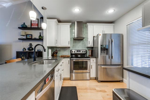 kitchen featuring white cabinetry, sink, wall chimney exhaust hood, and stainless steel appliances