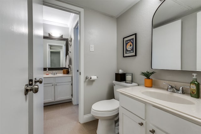 bathroom featuring tile patterned flooring, toilet, vanity, and ornamental molding