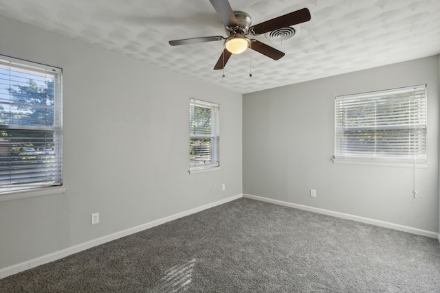 carpeted empty room featuring ceiling fan