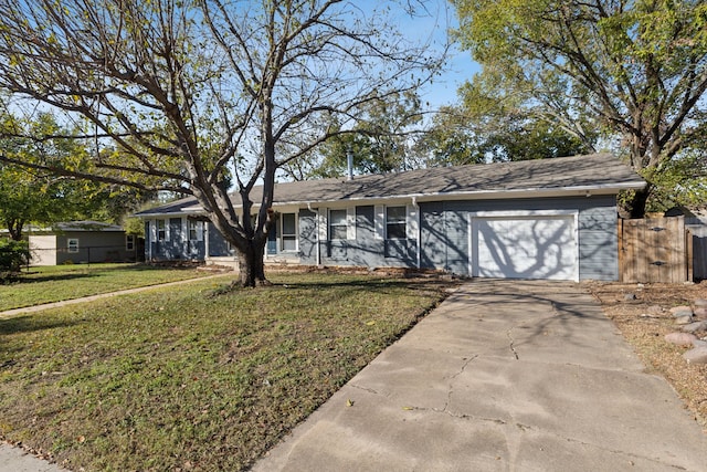 single story home featuring a garage and a front yard