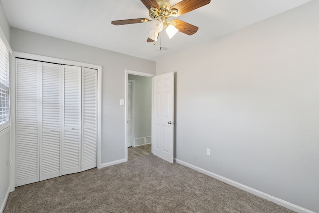 unfurnished bedroom featuring carpet flooring, ceiling fan, and a closet