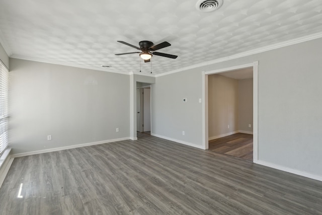 spare room featuring dark hardwood / wood-style floors, ceiling fan, and crown molding