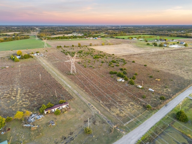 aerial view at dusk featuring a rural view