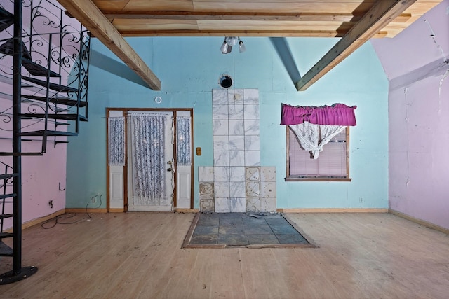 entrance foyer with beamed ceiling, wood-type flooring, and high vaulted ceiling