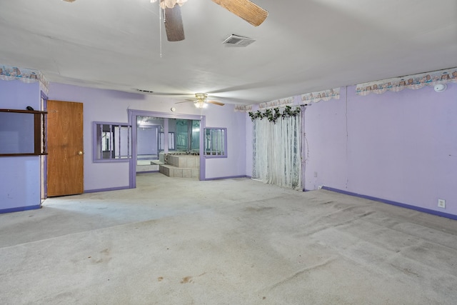 unfurnished living room featuring ceiling fan and light carpet