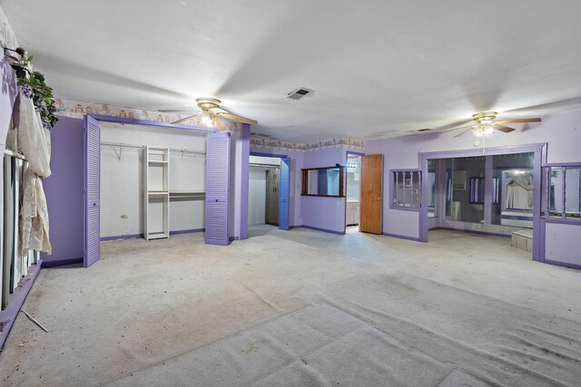 unfurnished living room with ceiling fan