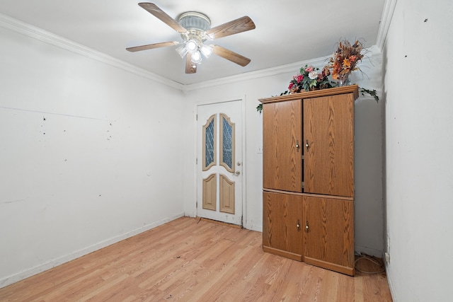 interior space featuring ceiling fan, light wood-type flooring, and ornamental molding