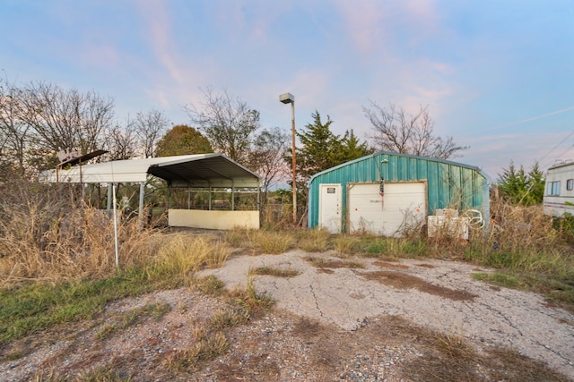 view of outbuilding featuring a garage and a carport