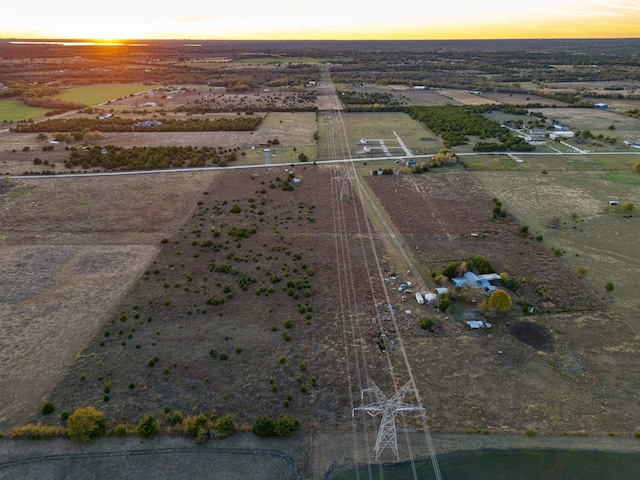 aerial view at dusk featuring a rural view