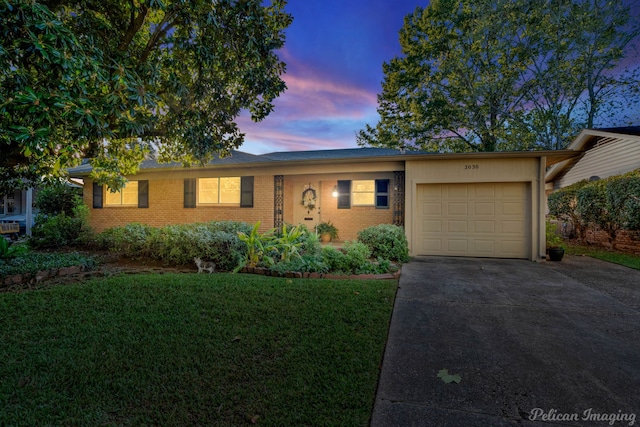 single story home with a yard and a garage