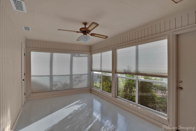 unfurnished sunroom with ceiling fan