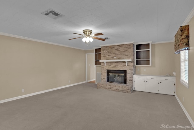 unfurnished living room with a fireplace, ornamental molding, ceiling fan, and carpet flooring