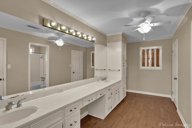 bathroom featuring vanity, crown molding,  shower combination, ceiling fan, and wood-type flooring