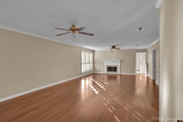 unfurnished living room with ceiling fan, hardwood / wood-style floors, and ornamental molding