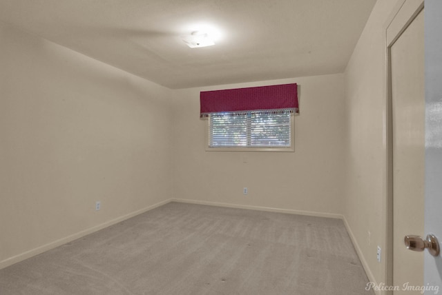 spare room featuring light colored carpet