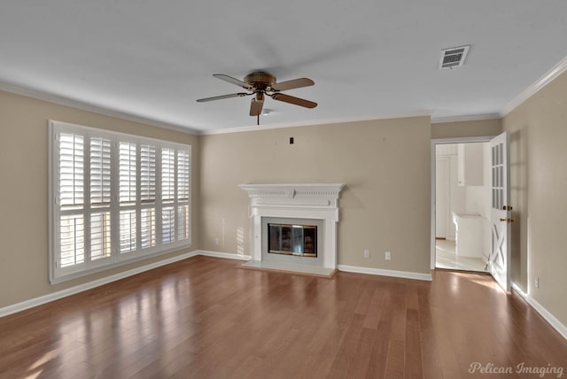 unfurnished living room featuring ornamental molding, ceiling fan, and wood-type flooring