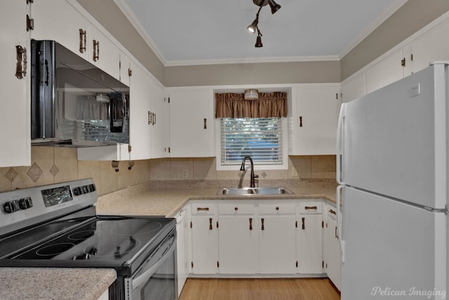 kitchen featuring stainless steel electric stove, white cabinetry, sink, and white fridge