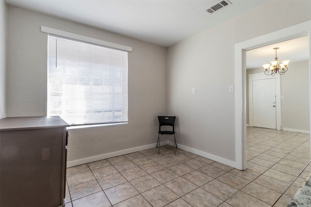 interior space with light tile patterned floors and an inviting chandelier