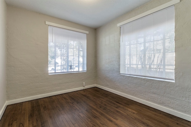 empty room with hardwood / wood-style floors