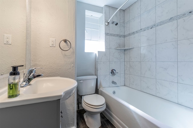 full bathroom with vanity, toilet, hardwood / wood-style flooring, and tiled shower / bath combo