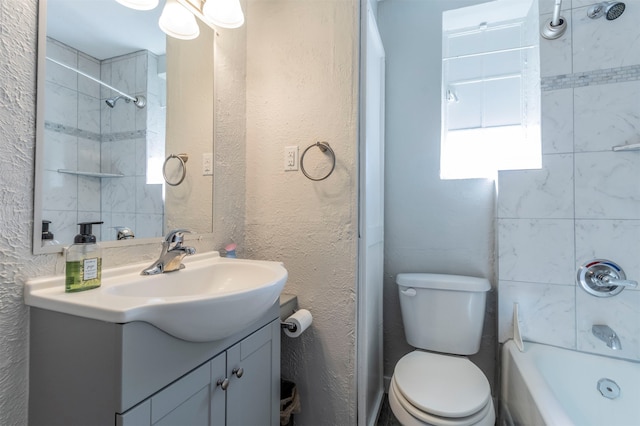 full bathroom with vanity, toilet, and tiled shower / bath combo