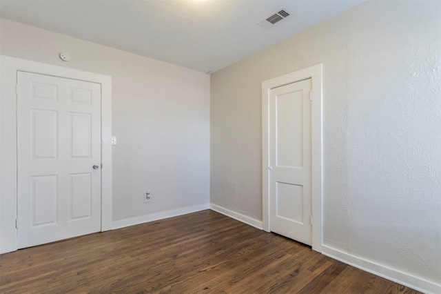 empty room featuring dark hardwood / wood-style flooring