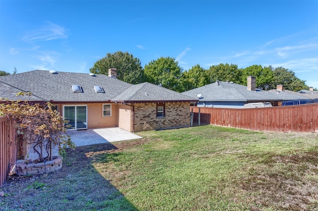 rear view of property featuring a yard and a patio